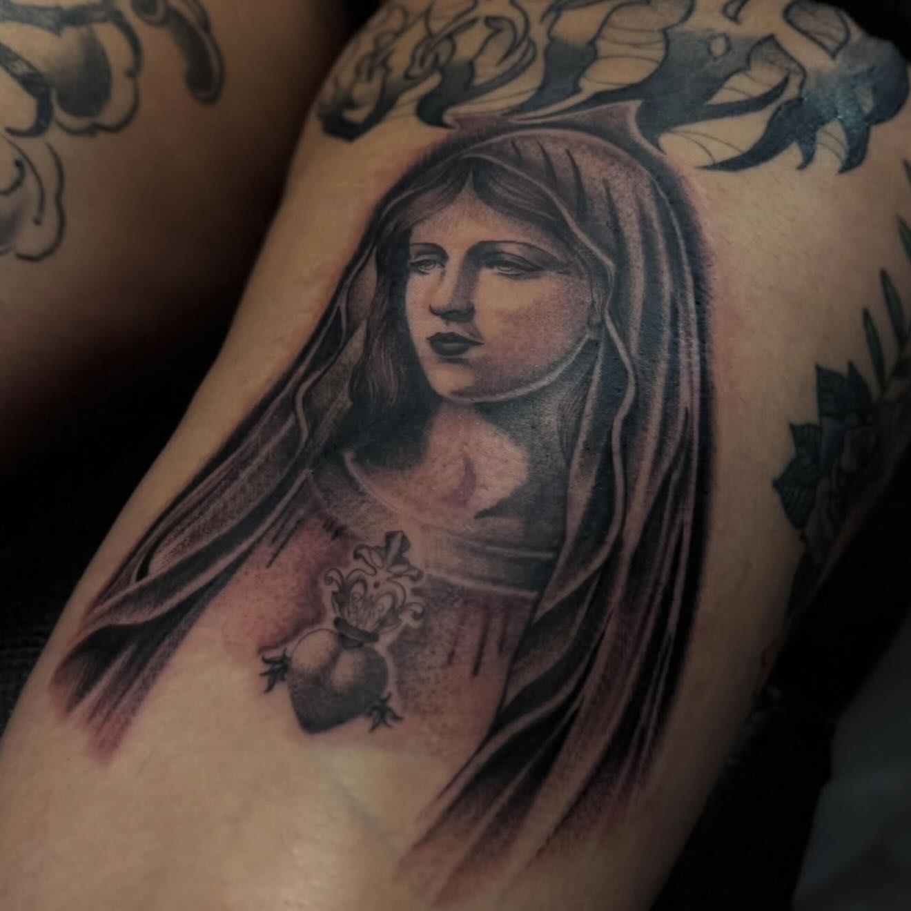 Black-and-grey veiled portrait tattoo