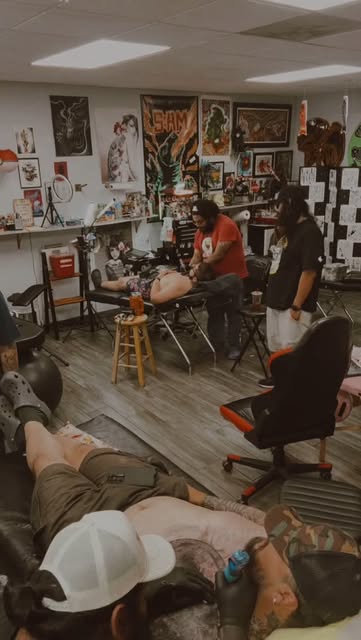 Public reel frame showing artists working inside Wild Wolf Tattoo Studio